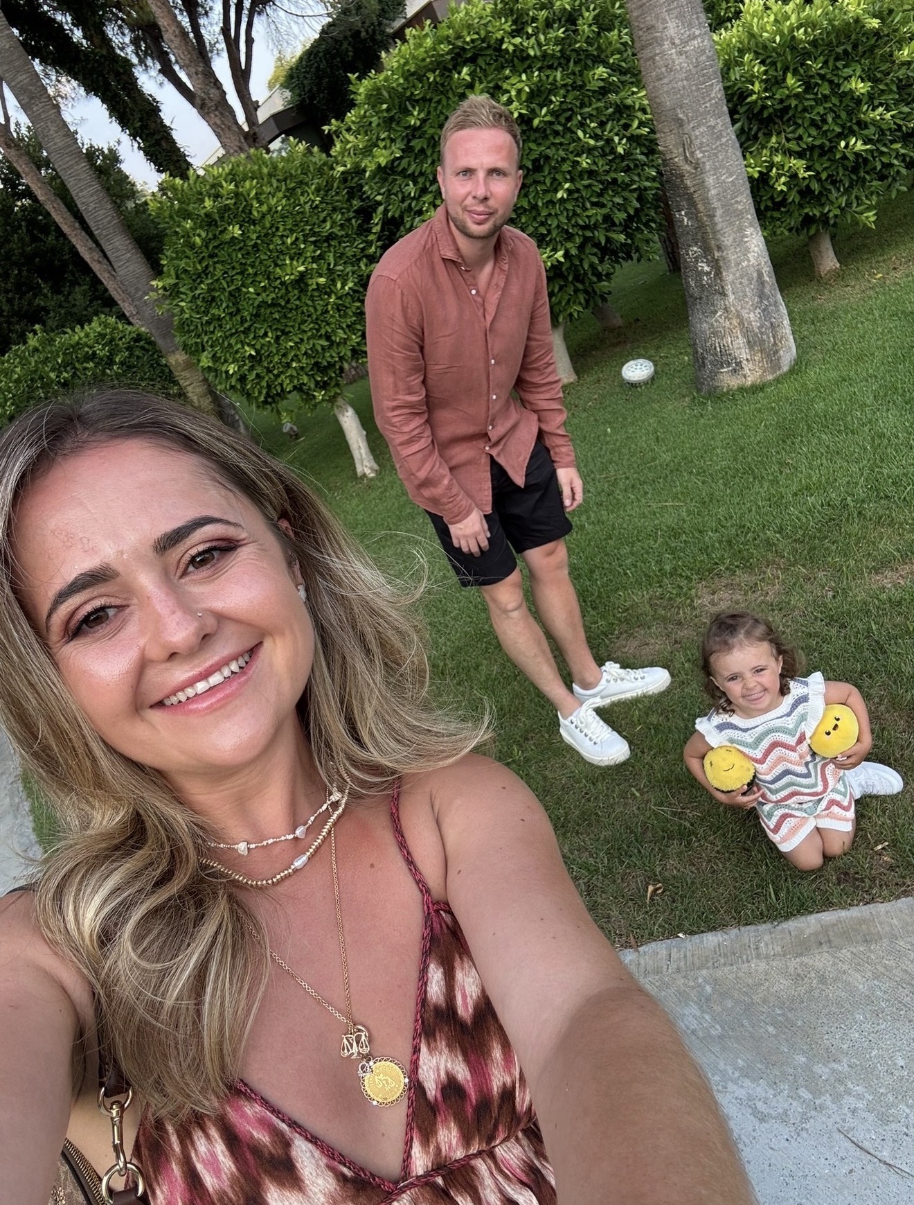 Layla with her partner and daughter on the grass