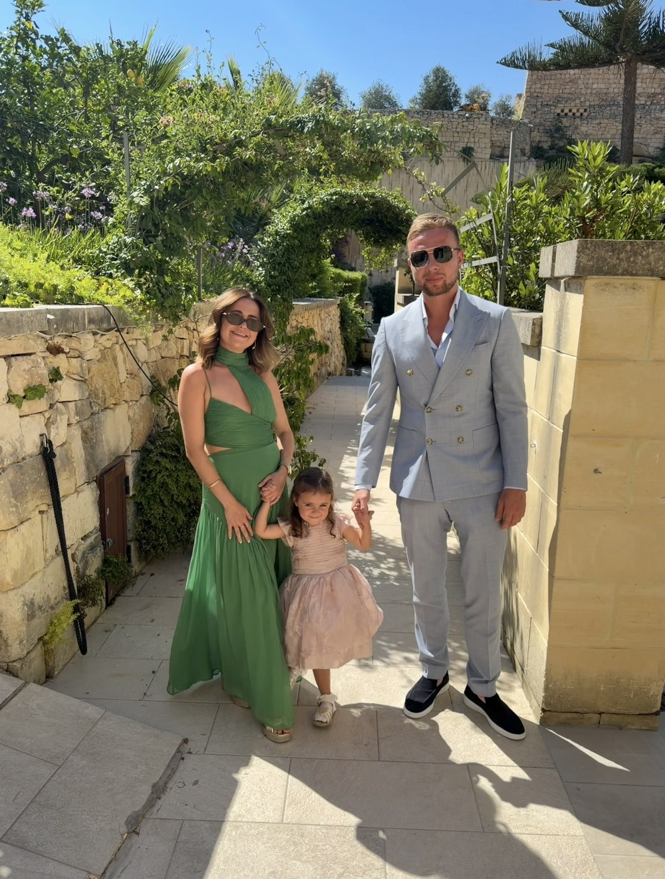 Layla in a green dress with her family